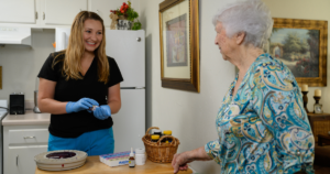 Image of a woman receiving home health care from a care provider in her home